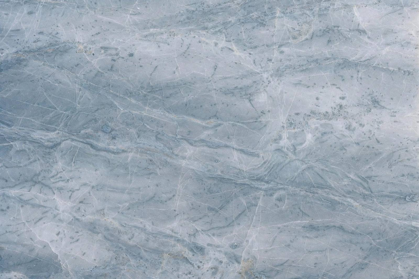 Polished quartzite slab surface with soft natural veining